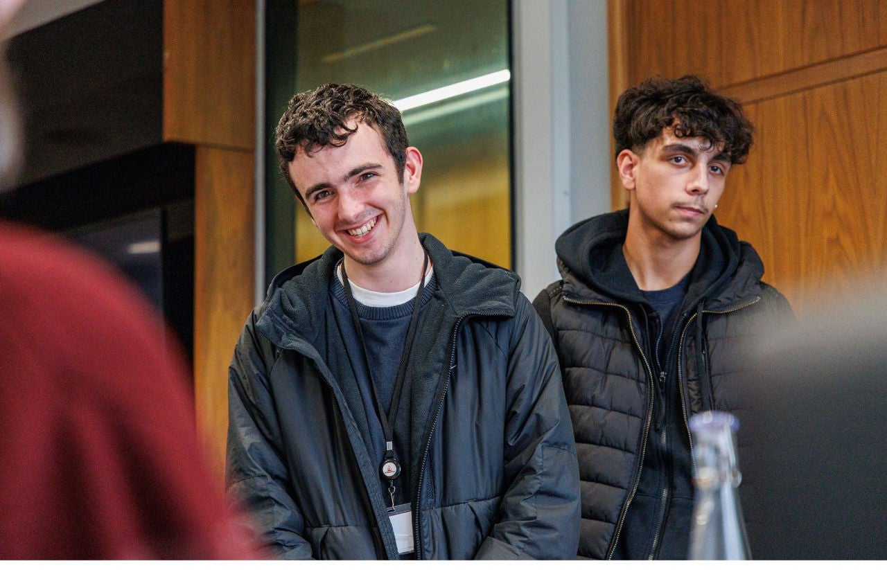young people presenting and smiling