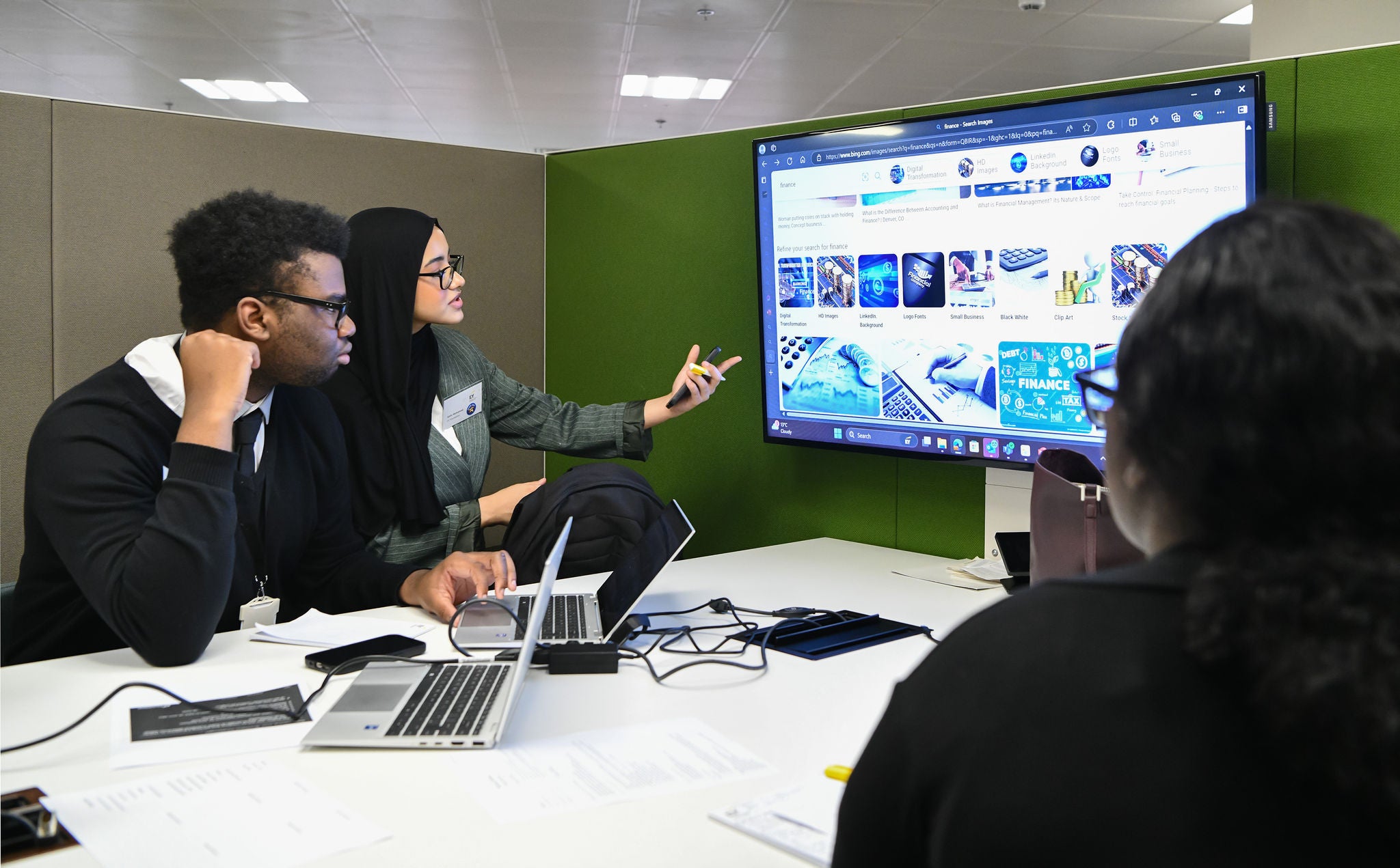 young people looking at monitor