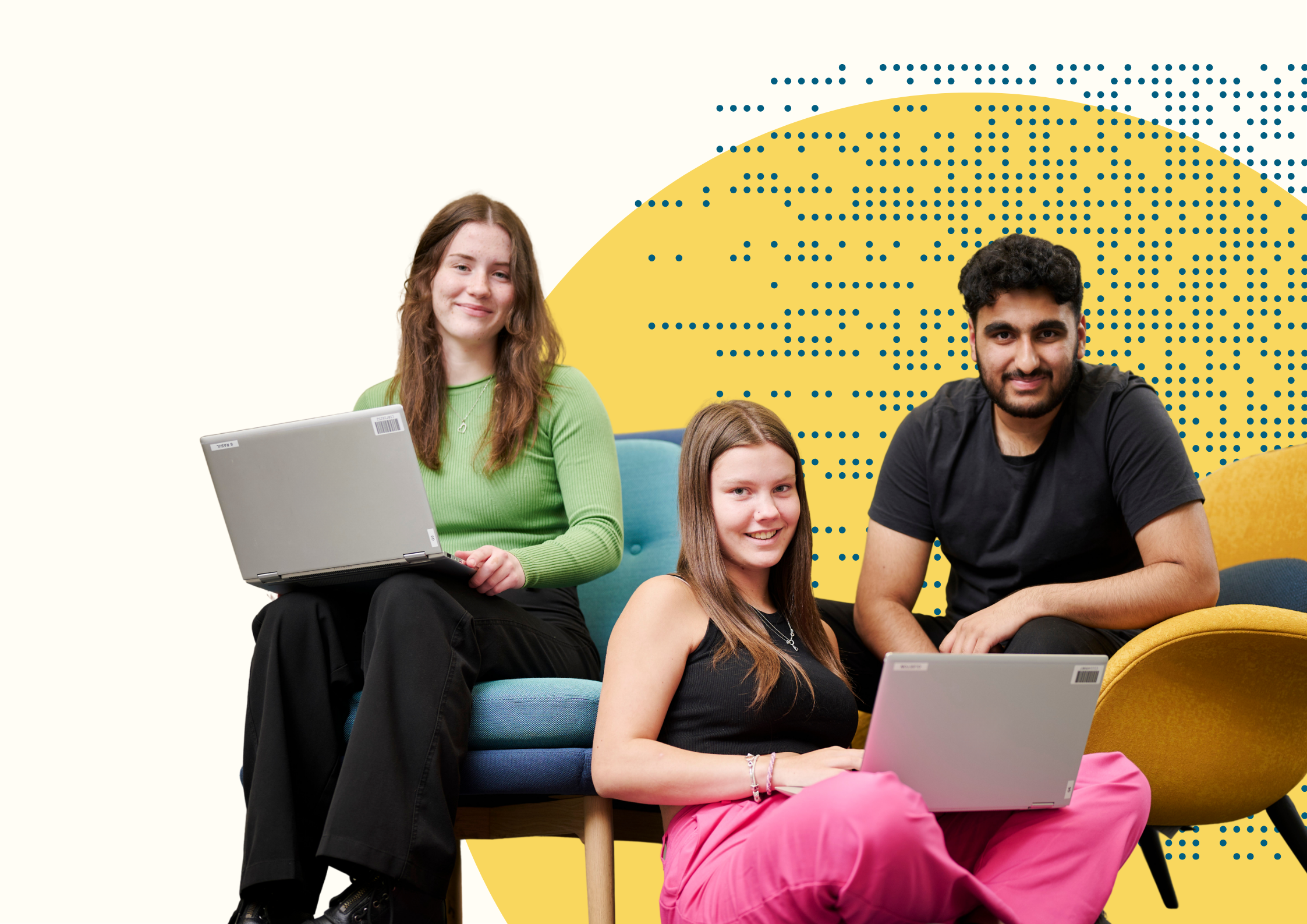 Photo of young people smiling with laptops in their laps.
