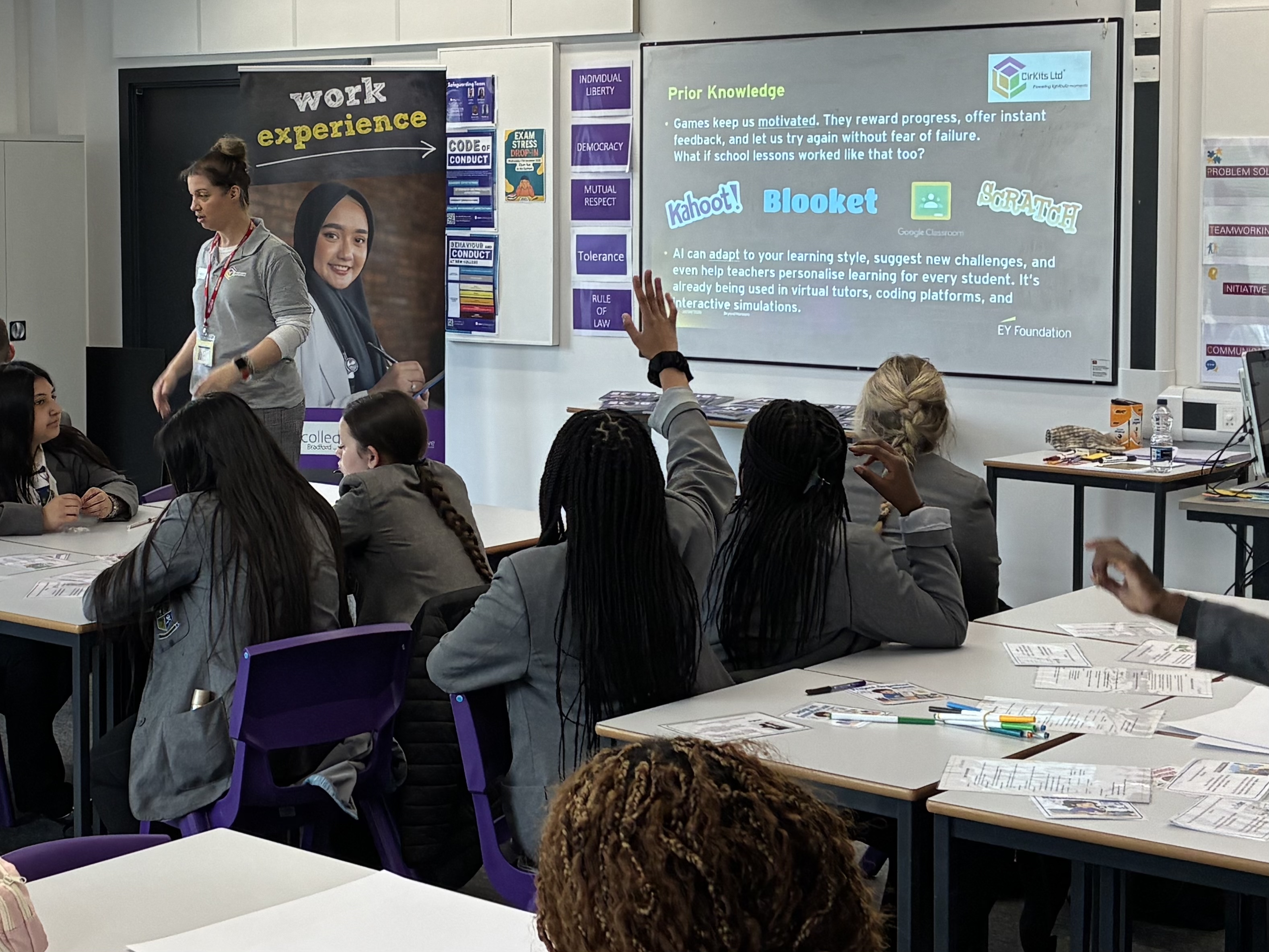 Photo of students and a volunteer in a classroom