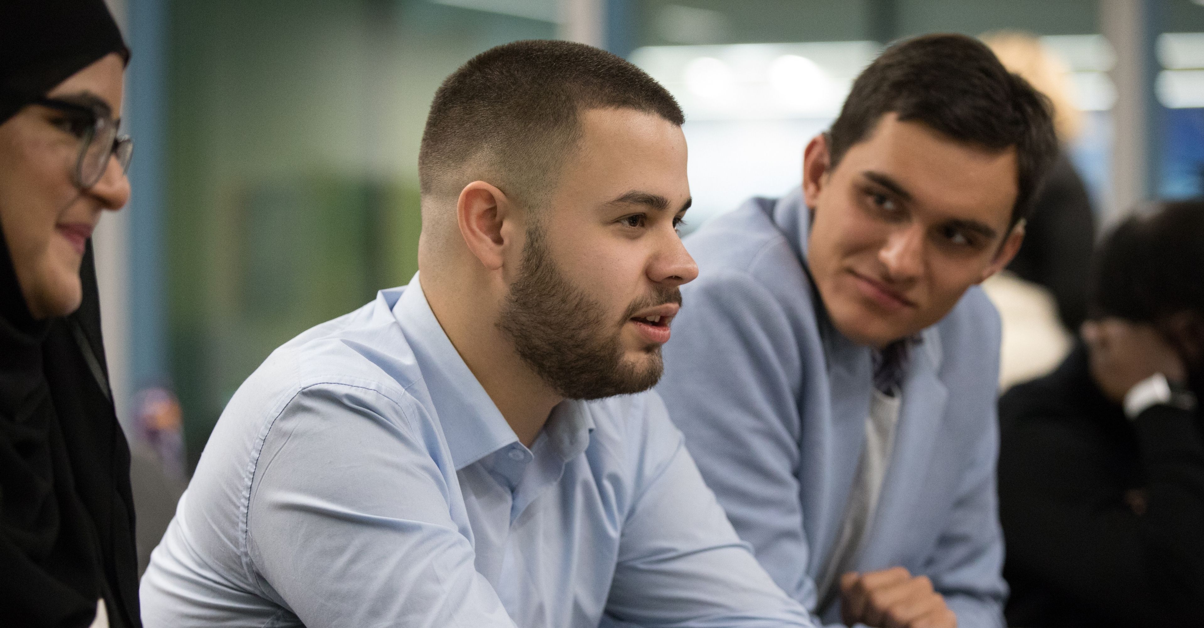 John conversing with peers